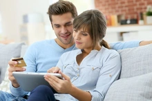 Young,Couple,Shopping,On,Internet,With,Tablet